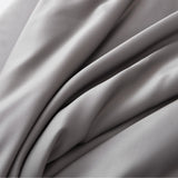 Elegant folds of Linenly's Bamboo Pillowcase Set in Stone Grey, made with smooth, soft grey fabric and a luxurious satin weave texture.